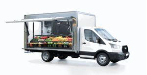 Photo of a truck with a side door open exposing produce.