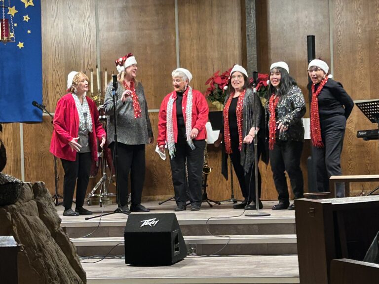 Photo of a group of women signing during a community concert.